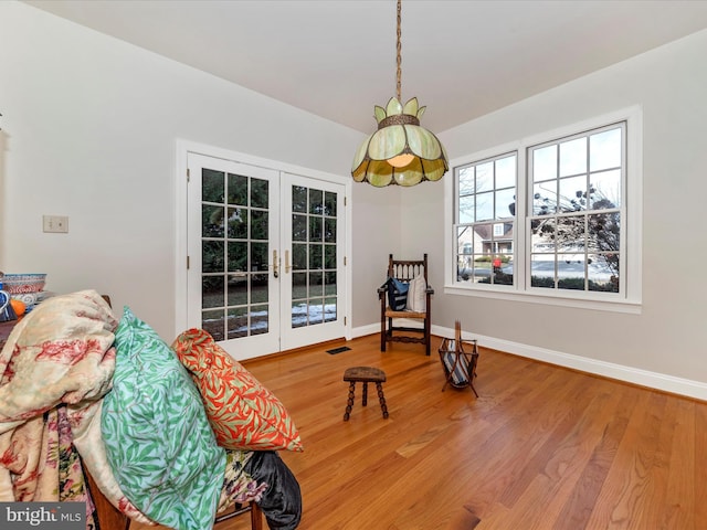 sitting room featuring wood-type flooring and french doors