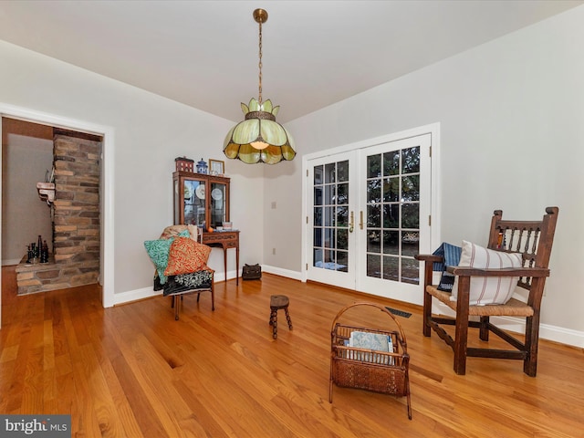 living area featuring wood-type flooring and french doors