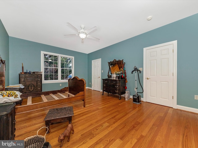 sitting room featuring ceiling fan and wood-type flooring