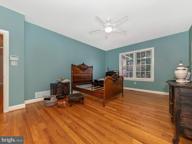 bedroom with ceiling fan and light hardwood / wood-style flooring