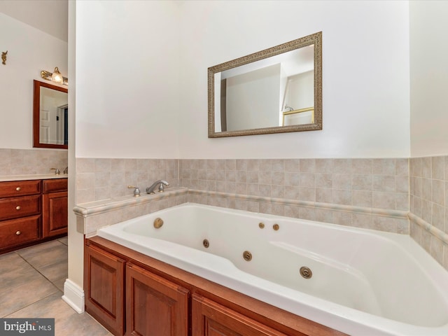 bathroom featuring vanity, a bathtub, and tile patterned floors