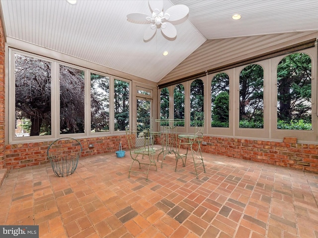 unfurnished sunroom featuring ceiling fan and lofted ceiling