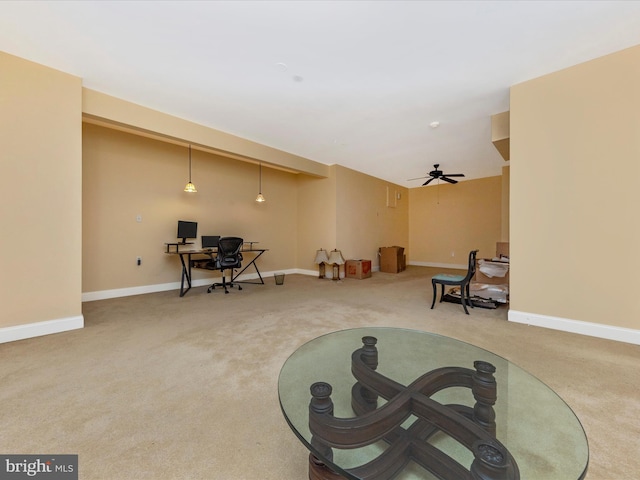 living area with carpet floors and ceiling fan