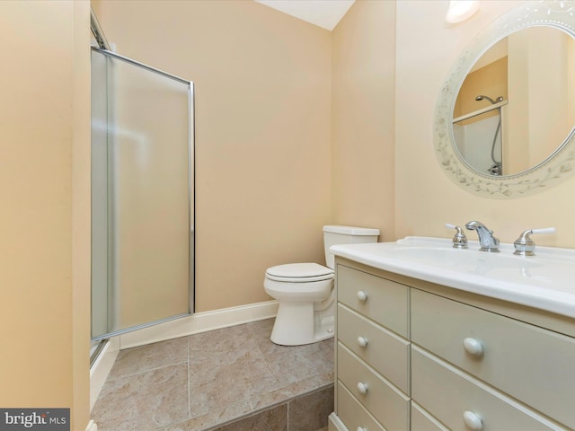 bathroom with tile patterned floors, vanity, toilet, and a shower with shower door