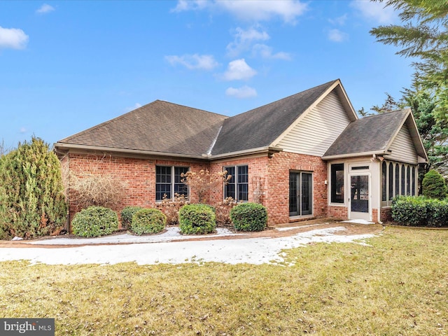 view of front of property with a front lawn and a sunroom