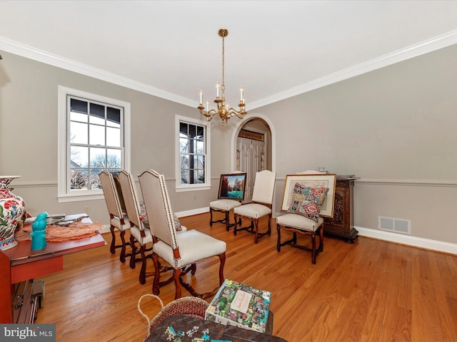 sitting room with an inviting chandelier, crown molding, and light hardwood / wood-style floors