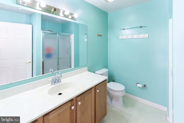 bathroom with vanity, an enclosed shower, and toilet