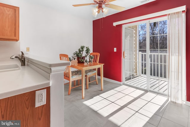 tiled dining room with sink and ceiling fan