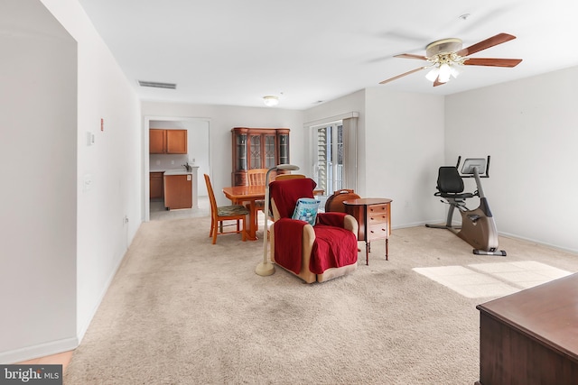 carpeted living room featuring ceiling fan