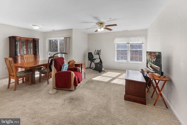 carpeted living room featuring ceiling fan