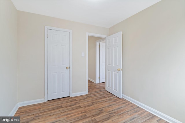 unfurnished bedroom featuring hardwood / wood-style floors