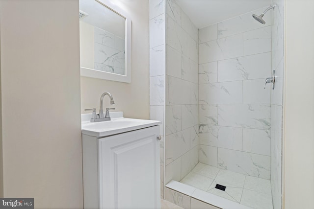 bathroom with vanity and tiled shower