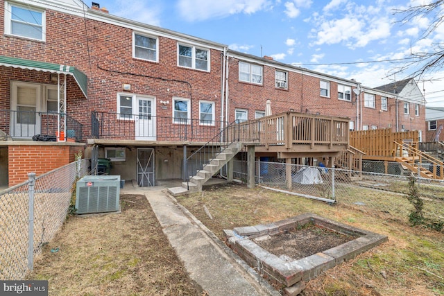 back of property with cooling unit and a deck