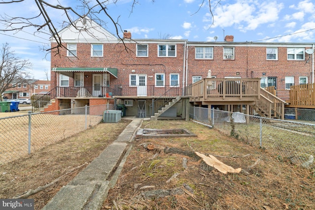 back of house with a deck and central air condition unit