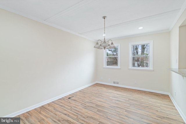 unfurnished dining area with a notable chandelier, crown molding, and light wood-type flooring