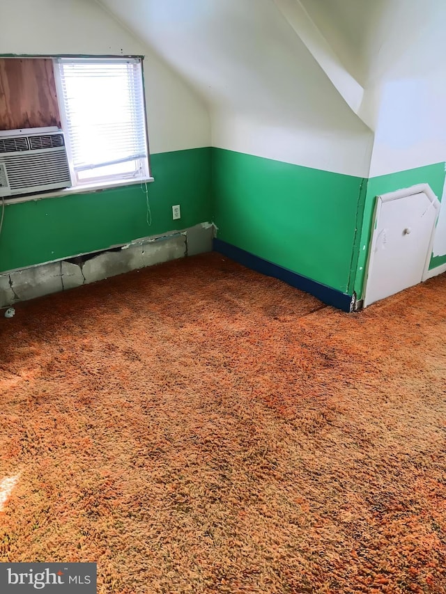 additional living space featuring lofted ceiling and carpet flooring