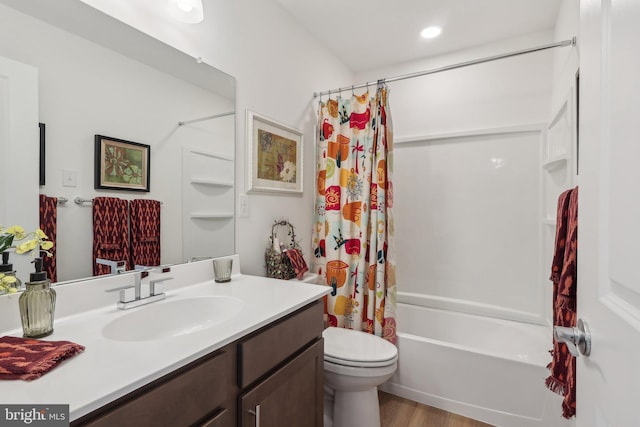 full bathroom with vanity, wood-type flooring, toilet, and shower / bath combo with shower curtain