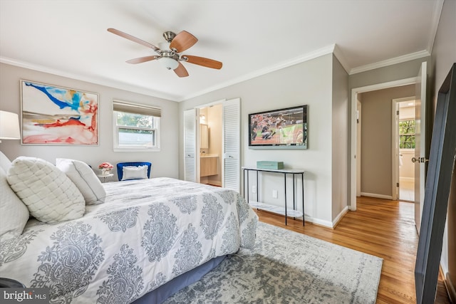 bedroom with ornamental molding, wood finished floors, baseboards, connected bathroom, and a ceiling fan
