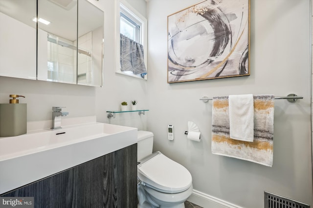bathroom with toilet, visible vents, and vanity