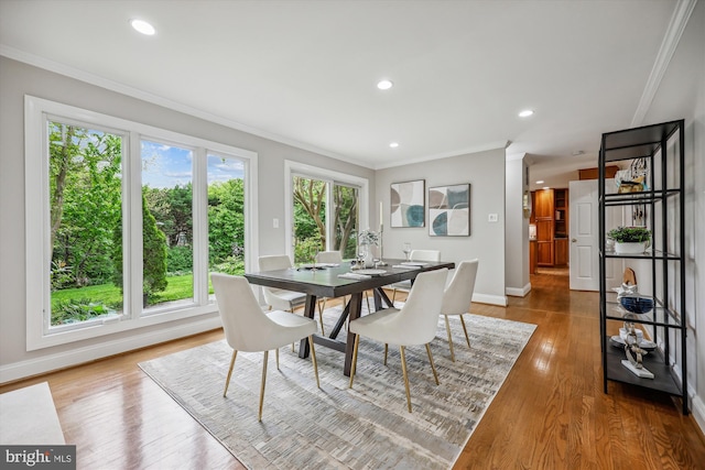 dining area featuring crown molding, recessed lighting, baseboards, and wood finished floors