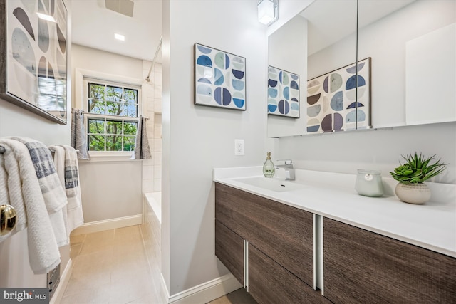 bathroom featuring tile patterned flooring, vanity, baseboards, shower / washtub combination, and visible vents