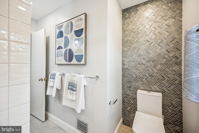 bathroom featuring visible vents, baseboards, and toilet