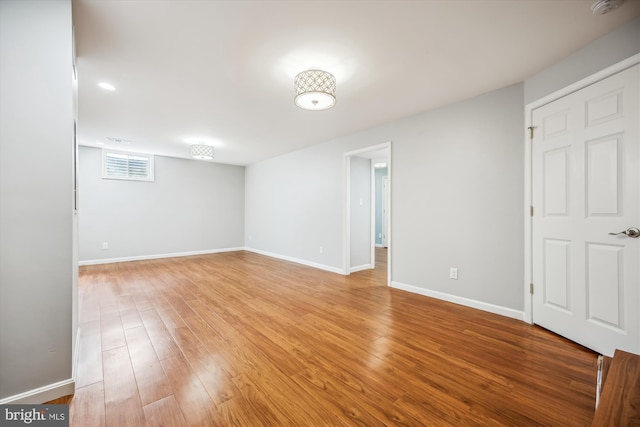 basement with light wood-style floors, baseboards, and visible vents