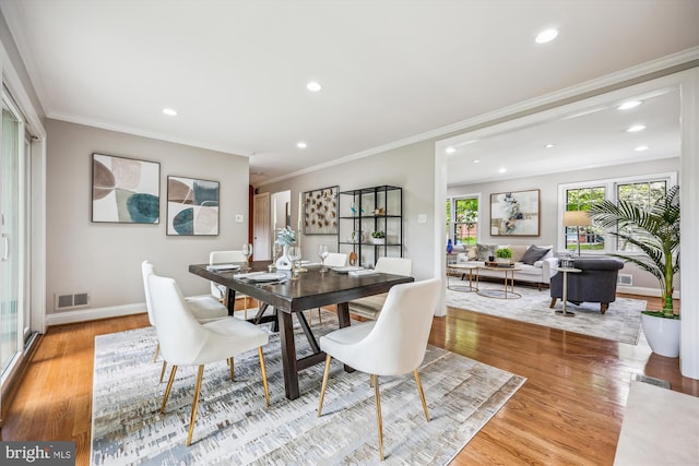 dining room with crown molding, recessed lighting, visible vents, and wood finished floors