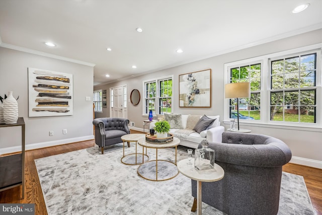 living room with recessed lighting, ornamental molding, baseboards, and wood finished floors