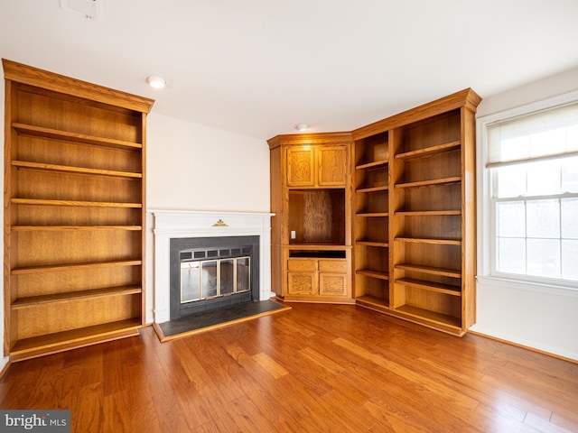 unfurnished living room featuring hardwood / wood-style flooring