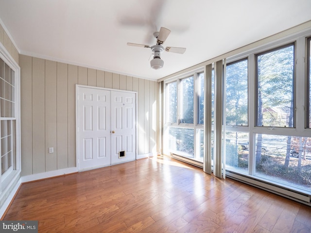 interior space with crown molding, light hardwood / wood-style flooring, and baseboard heating