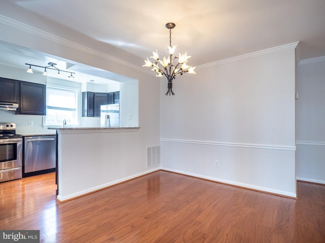 kitchen with a notable chandelier, stainless steel appliances, crown molding, light stone countertops, and light hardwood / wood-style flooring