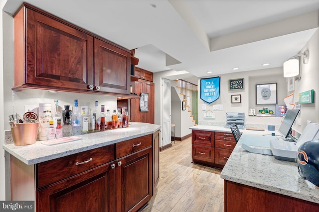 kitchen featuring light stone countertops and light hardwood / wood-style flooring