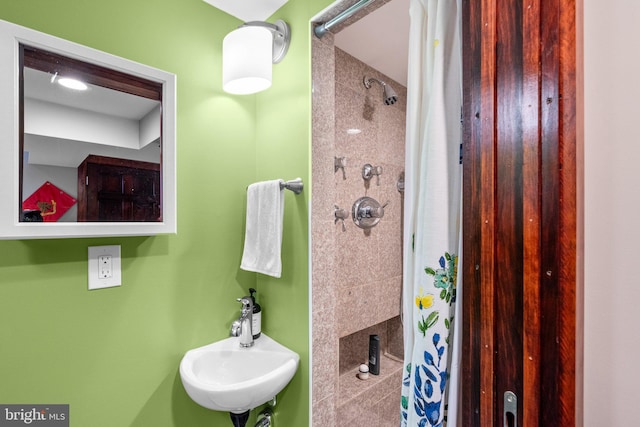 bathroom with sink and a shower with shower curtain