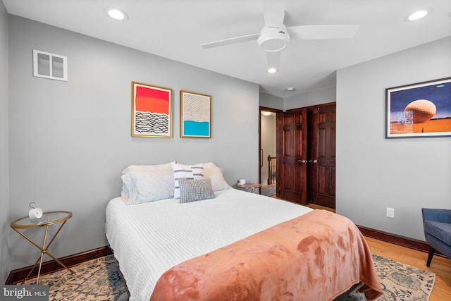 bedroom with ceiling fan and light wood-type flooring