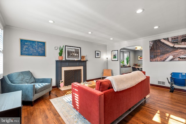 living room featuring dark hardwood / wood-style flooring and crown molding