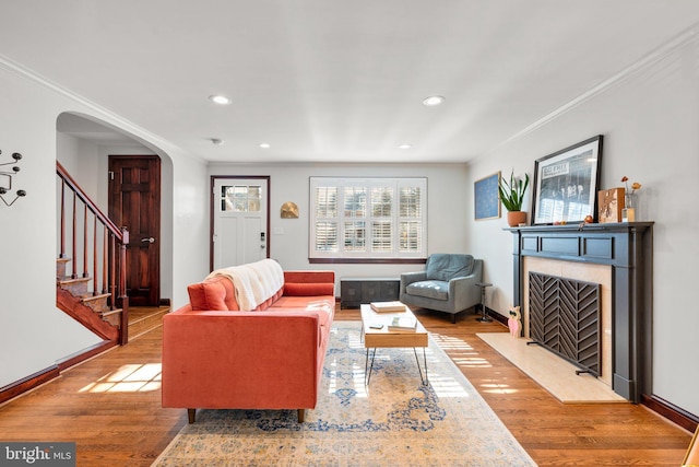 living room with crown molding and hardwood / wood-style floors