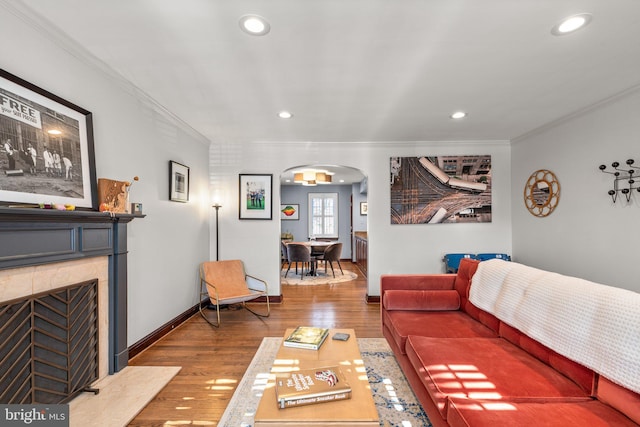 living room with hardwood / wood-style floors and crown molding