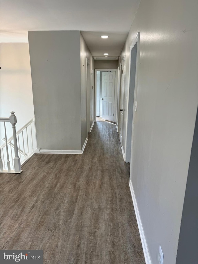 hallway with dark hardwood / wood-style flooring