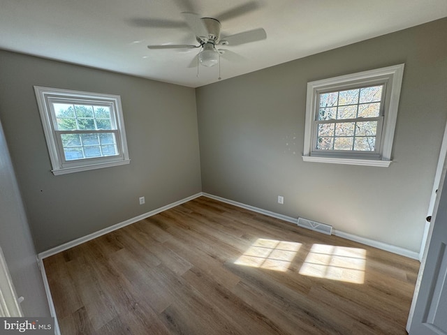 empty room with ceiling fan and light wood-type flooring