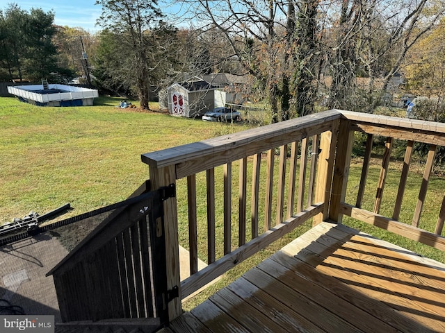 deck featuring a lawn and a storage unit