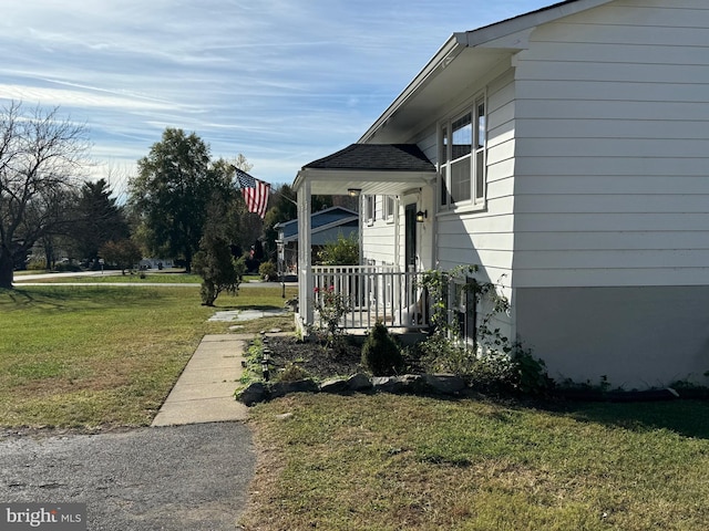 view of side of home featuring a lawn