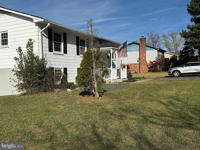 view of side of property featuring a yard