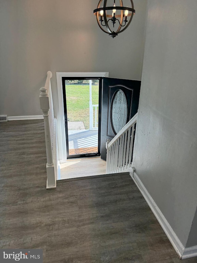 entrance foyer with dark hardwood / wood-style floors and a chandelier