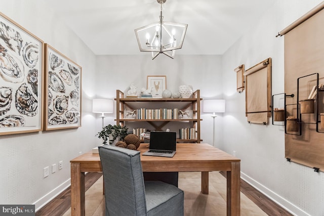 office area with hardwood / wood-style floors and a notable chandelier