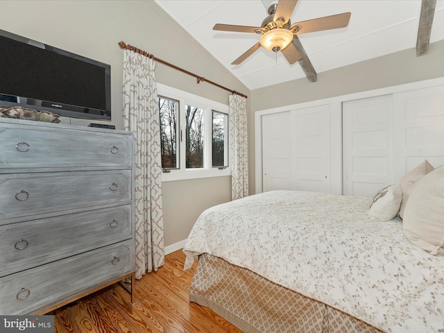 bedroom featuring hardwood / wood-style flooring, ceiling fan, lofted ceiling, and a closet