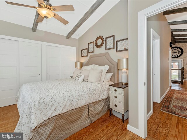 bedroom with ceiling fan, lofted ceiling with beams, and light wood-type flooring