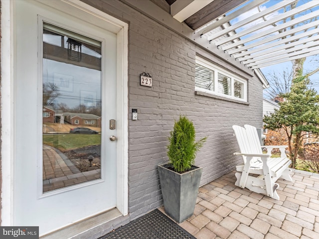 entrance to property with a pergola