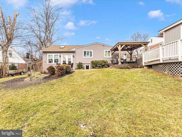 back of house featuring a gazebo, a yard, and a wooden deck