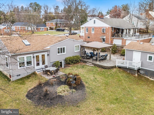 back of house featuring a gazebo, a yard, a deck, and a patio